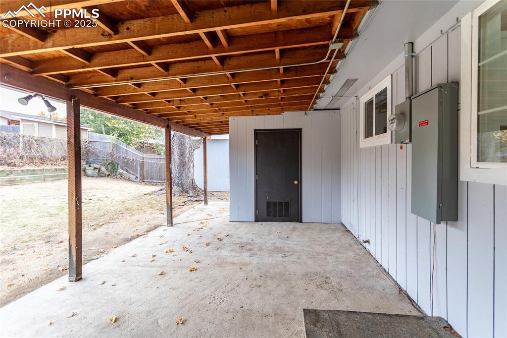 Image 39 of 50: The large covered patio with a skylight.  It also shows the attached shed f