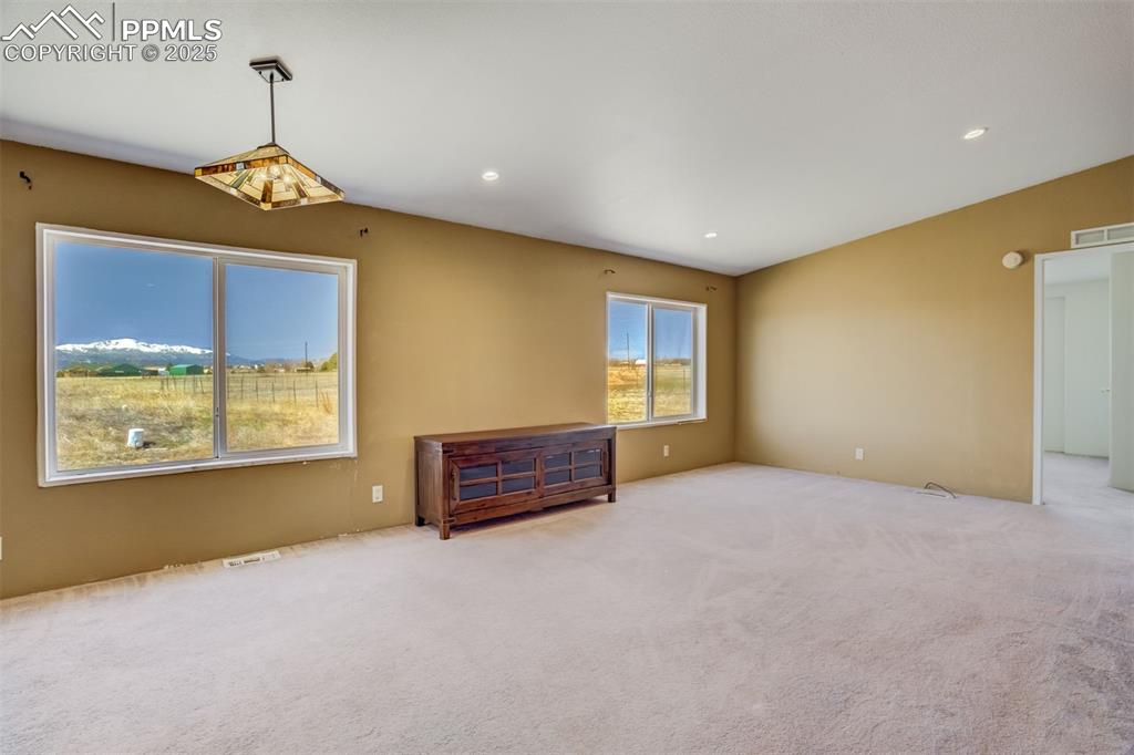 Image 13 of 50: Unfurnished room featuring visible vents, recessed lighting, carpet, and lo