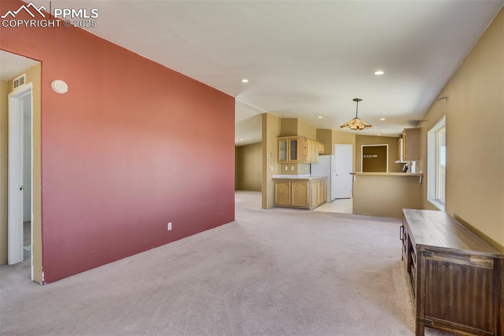 Image 15 of 50: Unfurnished living room featuring visible vents, recessed lighting, and lig
