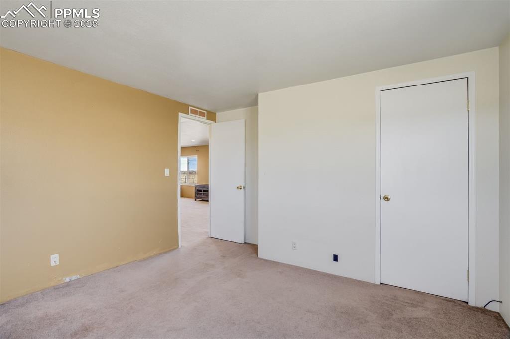 Image 31 of 50: Carpeted spare room with visible vents