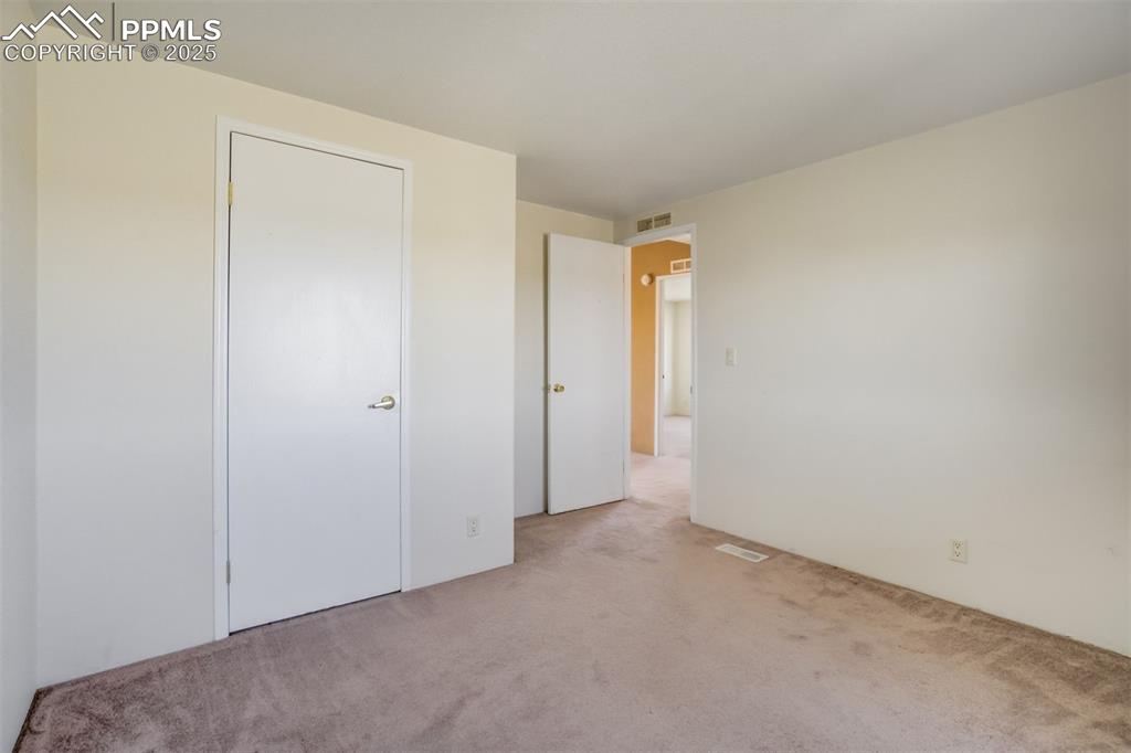 Image 33 of 50: Unfurnished bedroom featuring carpet and visible vents
