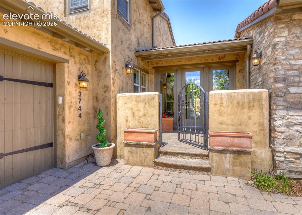 Image 3 of 50: Private gated courtyard entry