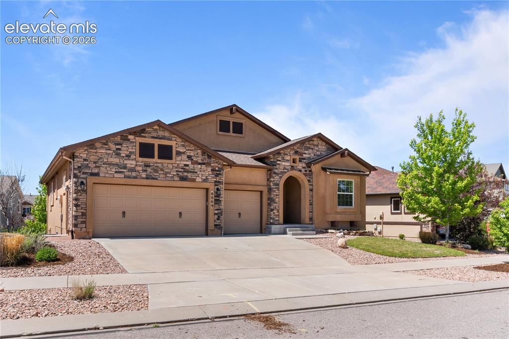Image 2 of 37: 3 car garage, walkout, expansive deck and basement.