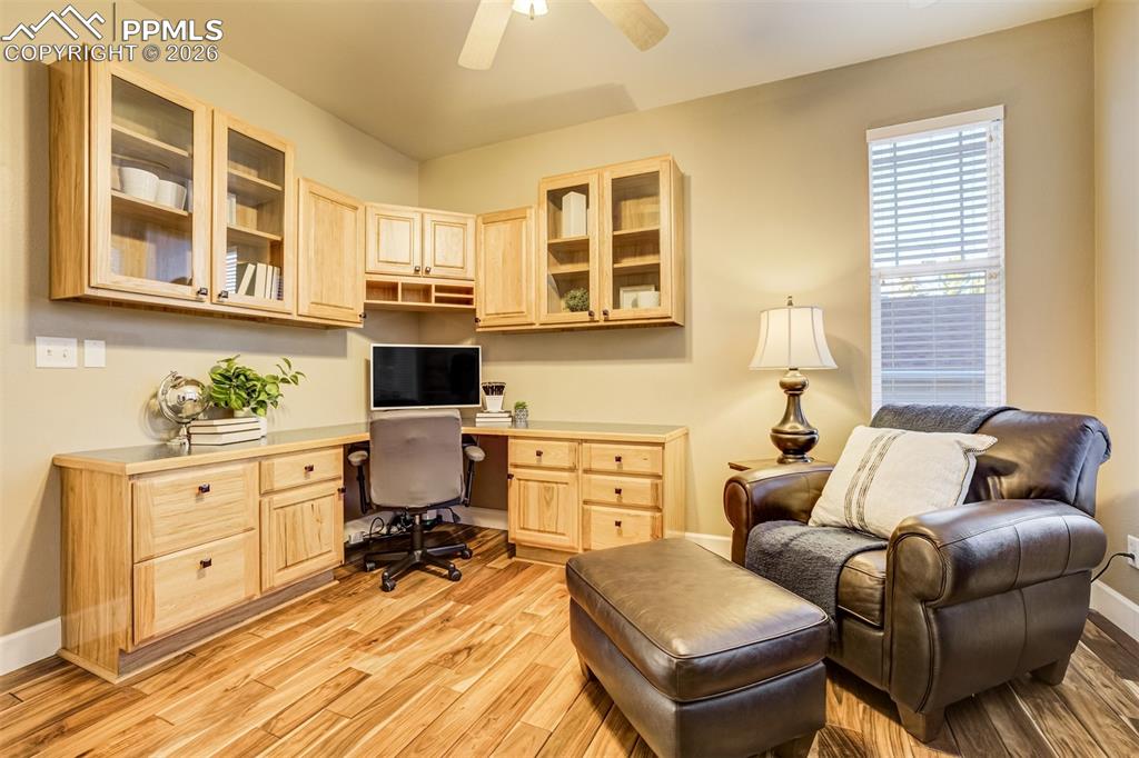 Image 18 of 50: An executive style office with built in cabinetry and work space