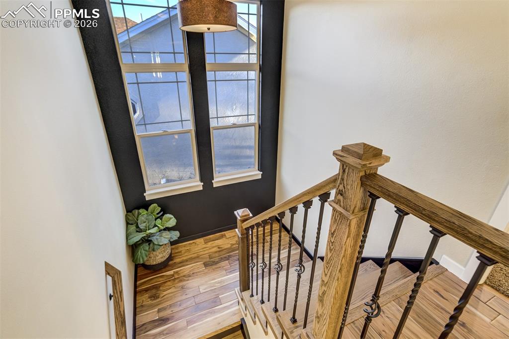 Image 20 of 50: Gorgeous acacia flooring continues up the stairs to upper level