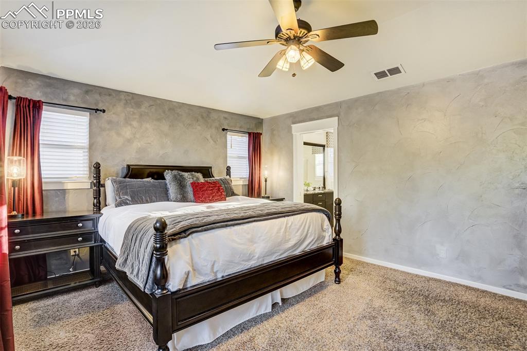 Image 23 of 50: Enjoy an elevated primary suite complete with a door to the bathroom