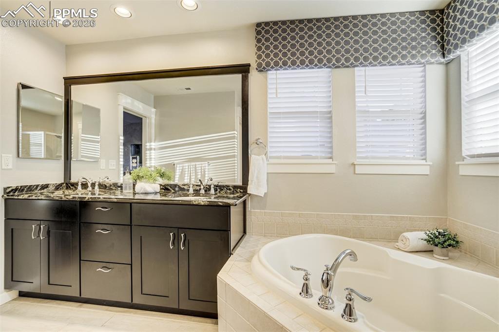 Image 25 of 50: Enjoy a double vanity with granite countertops