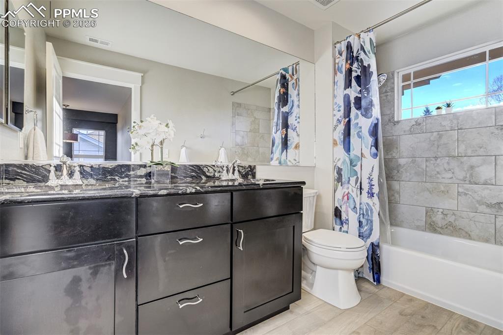 Image 32 of 50: Full bathroom on upper level with granite counter and double vanity