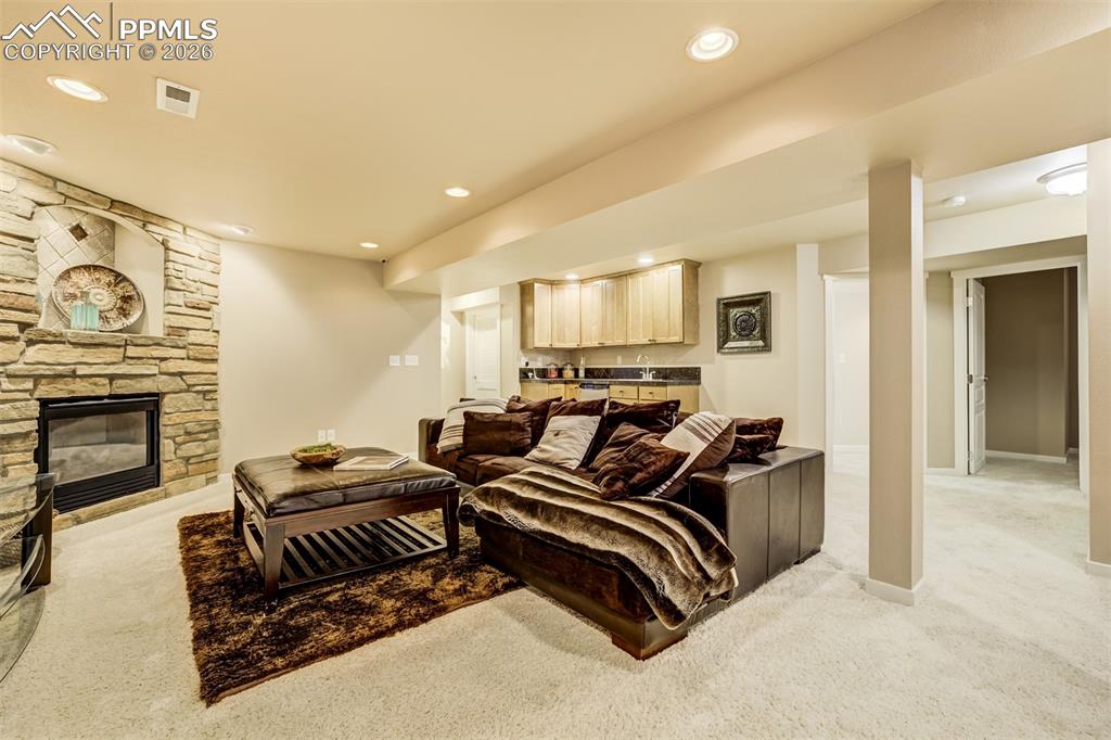 Image 35 of 50: A fireplace and wet bar provide a perfect space for a movie night!