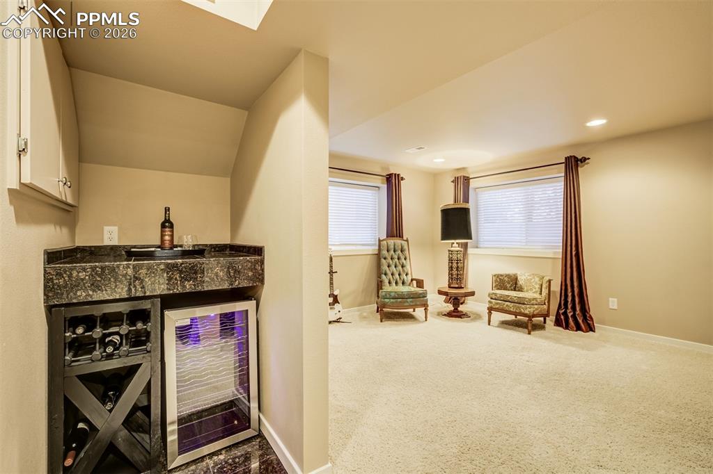 Image 36 of 50: A beverage station make a nice touch to the other half of the basement