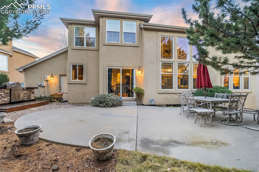 Image 49 of 50: The backyard is a private oasis surrounded by mature trees