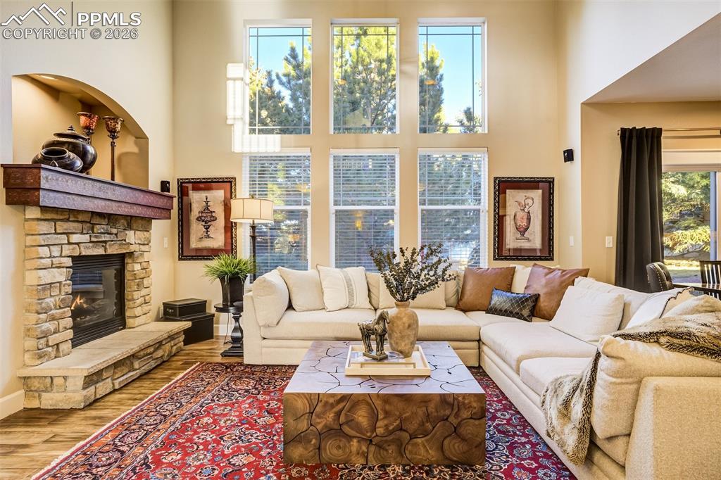 Image 5 of 50: The stunning custom fireplace is the focal point of the family room