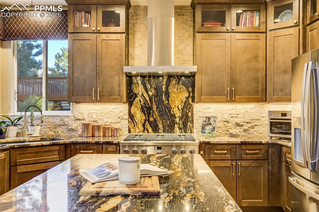 Image 9 of 50: Elevated kitchen with granite and tile is stunning!