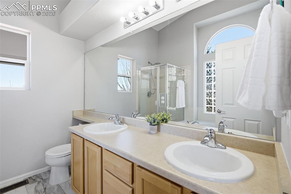 Image 15 of 36: Primary bedroom with en suite primary bath and walk-in closet