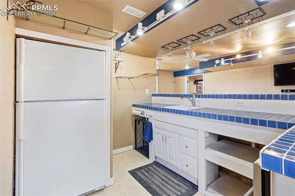 Image 26 of 36: Large basement game room overlooking wet bar area