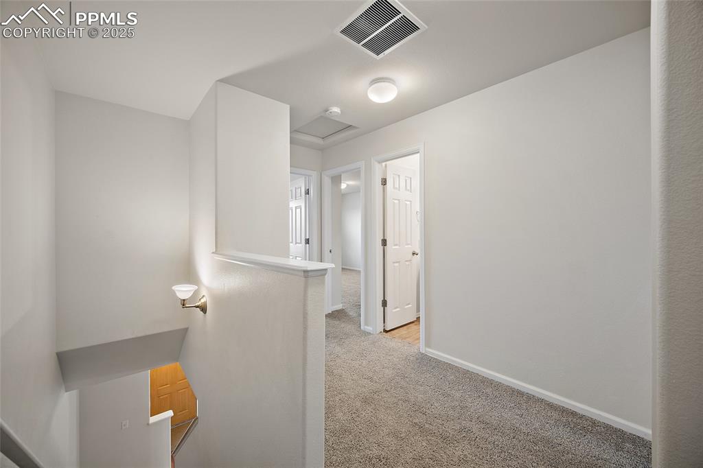 Image 18 of 33: Wide hallway on the upper level.   