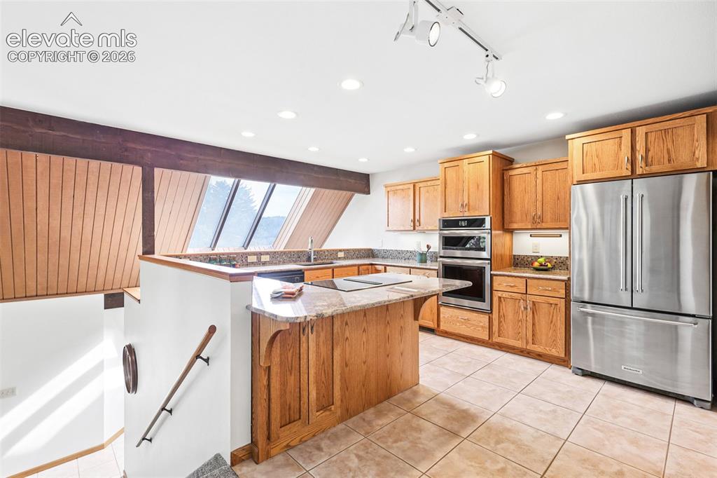 Image 13 of 41: This well-planned kitchen features recessed lighting, under-the-counter lig