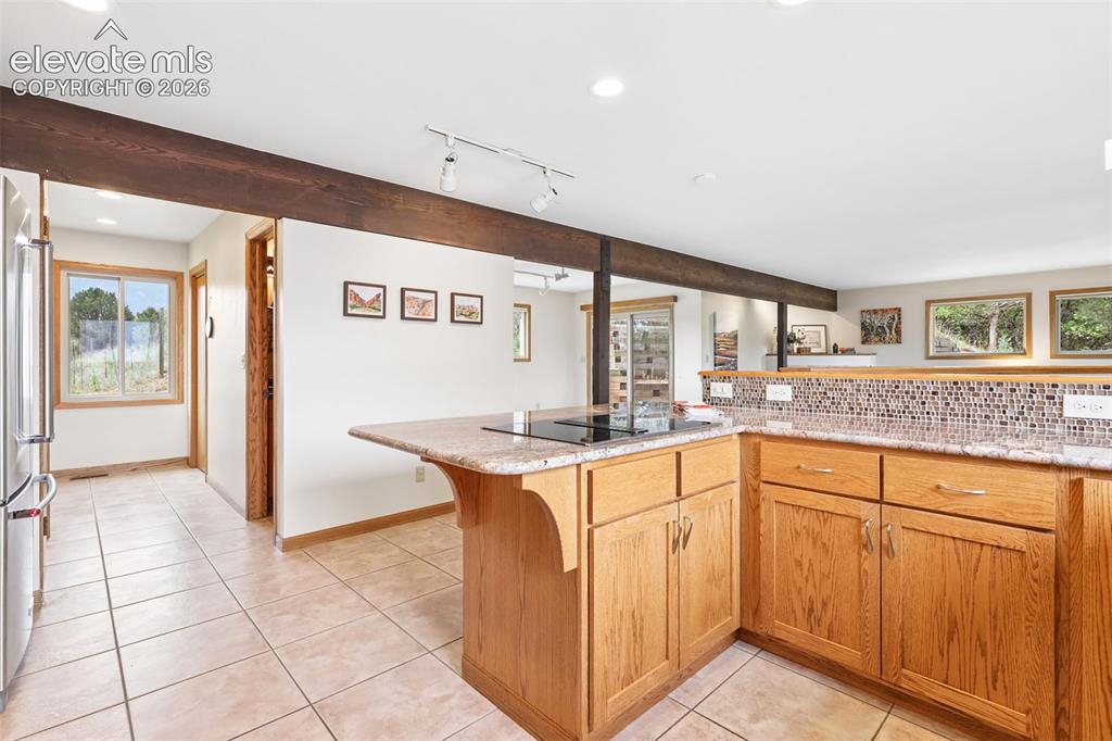 Image 14 of 41: Down the hallway is a pantry, desk area, laundry, and 1/2 bath.
