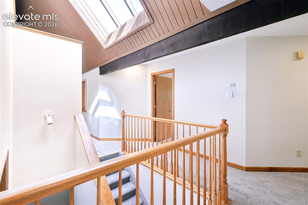 Image 17 of 41: Open hallway to main level bedrooms and office/studio in lower level. The