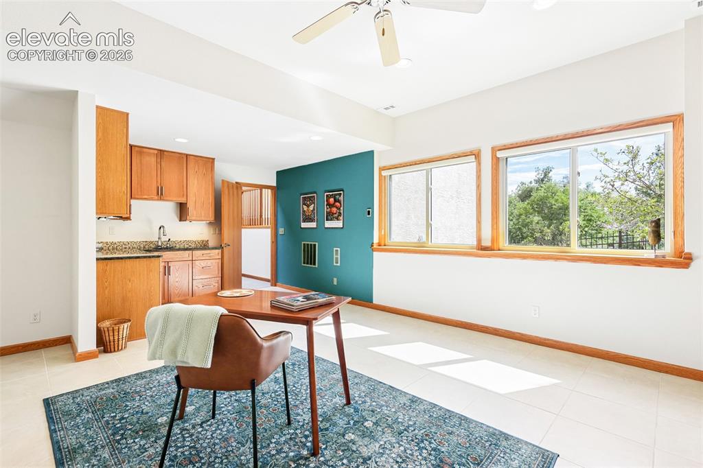 Image 27 of 41: Large expansive office/studio with radiant heated flooring, wet bar, and cu