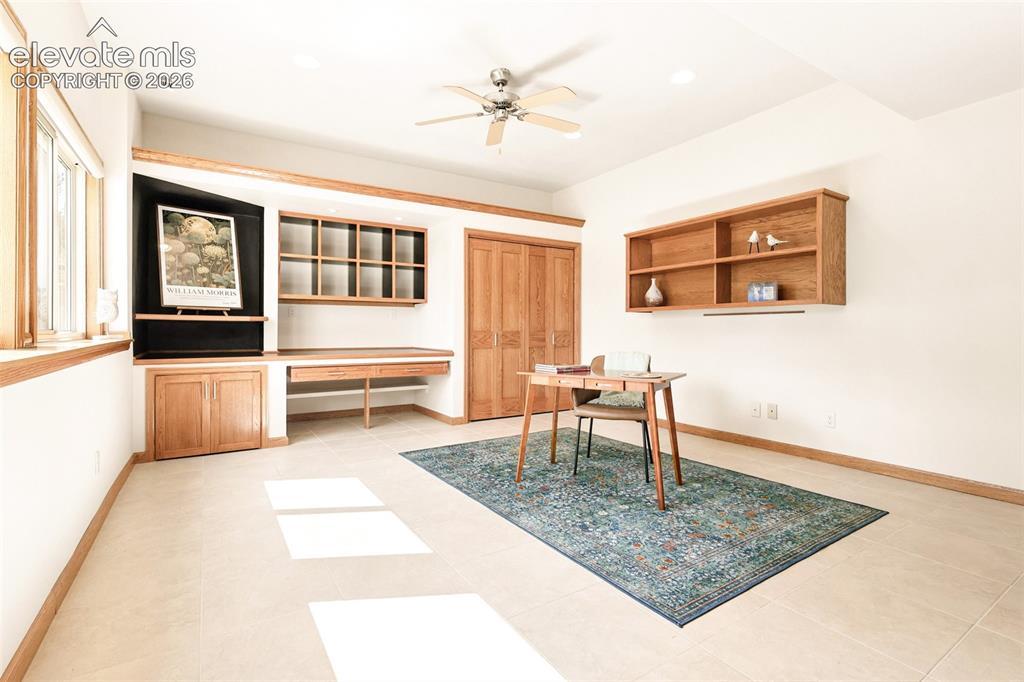 Image 29 of 41: The large private office/studio boasts a wall of windows providing natural 