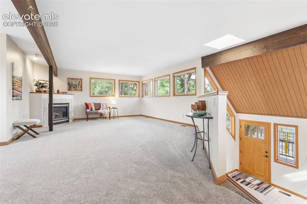 Image 8 of 41: The living room is flooded with light from the abundance of windows.