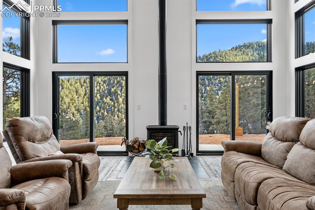 Image 8 of 30: Breathtaking views through floor-to-ceiling windows, custom sawblade fir fl