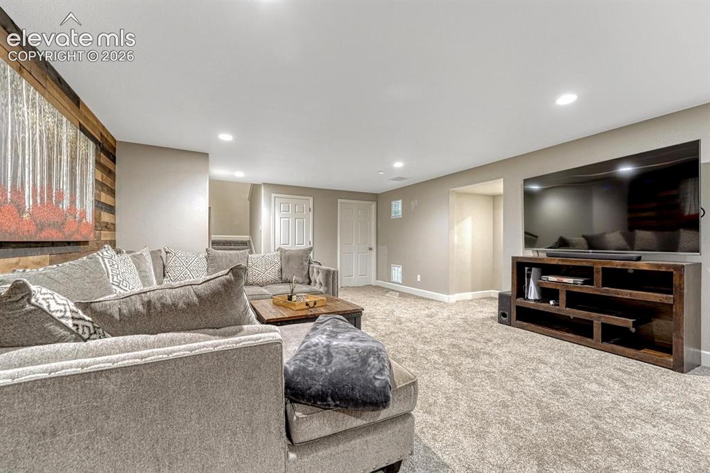 Image 22 of 44: Recessed ceiling lighting, textured wall accent, light neutral wall paint, 