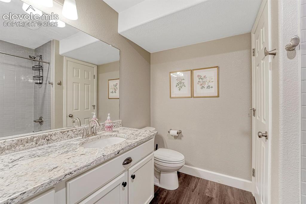 Image 25 of 44: Vanity with integrated sink, white cabinetry, and light-toned countertop