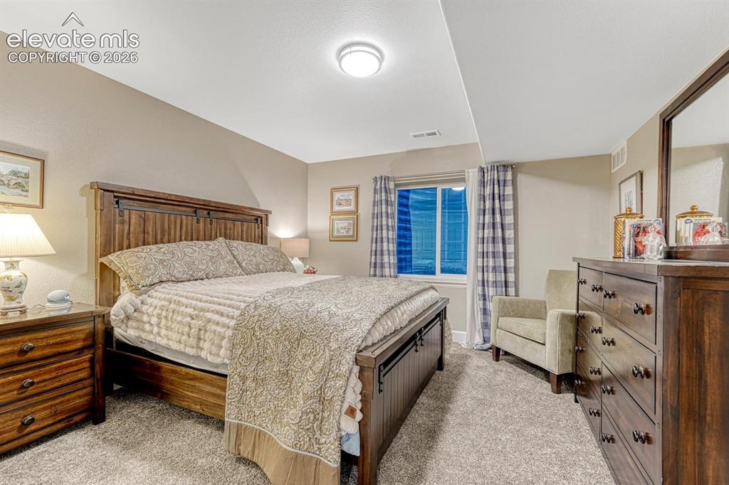 Image 26 of 44: Recessed ceiling lighting, neutral-toned walls, gray-toned carpeting, windo