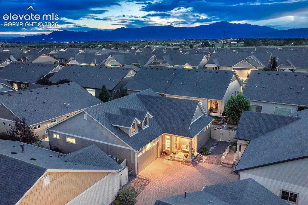 Image 34 of 44: Mountain backdrop, residential neighborhood setting, asphalt shingle roofin