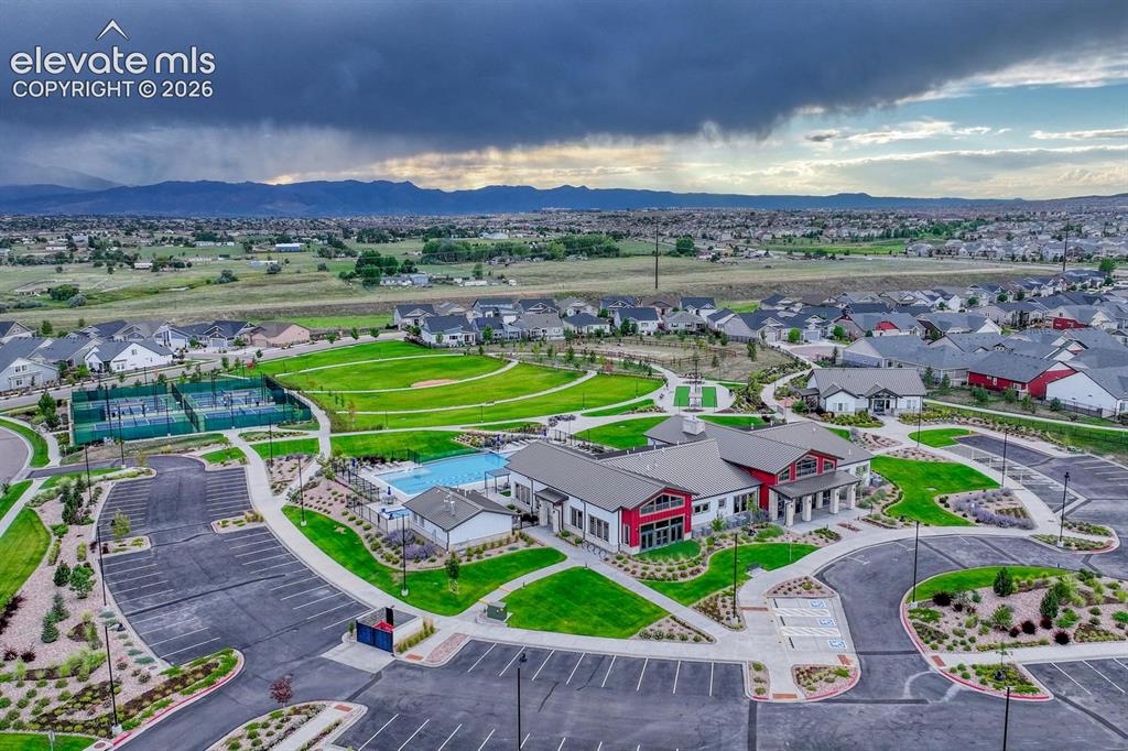 Image 37 of 44: Community amenities featuring tennis courts, a swimming pool, open green sp