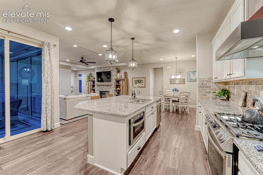 Image 9 of 44: Kitchen island with granite countertop and undermount sink