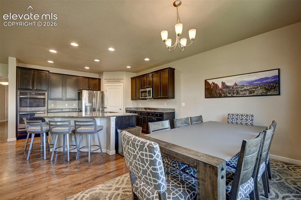 Image 22 of 40: Spacious kitchen featuring dark cabinetry, stainless steel appliances, and 