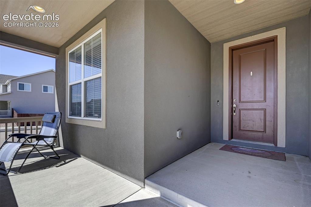Image 3 of 40: Covered front entry featuring a paneled door, recessed lighting, and a fron