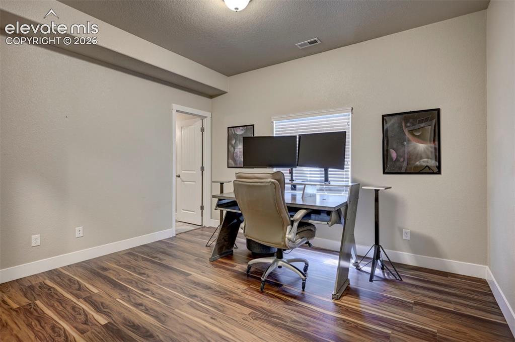 Image 38 of 40: Wood-finish flooring, neutral wall tones, and white trim throughout