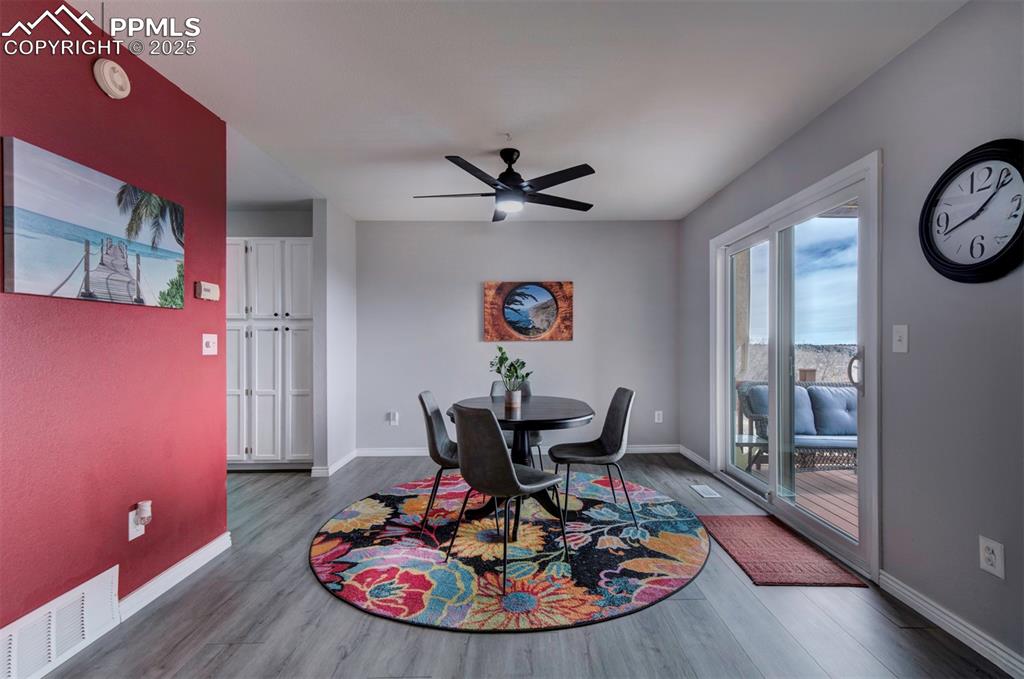 Image 18 of 50: Dining room featuring baseboards, visible vents, wood finished floors, and 