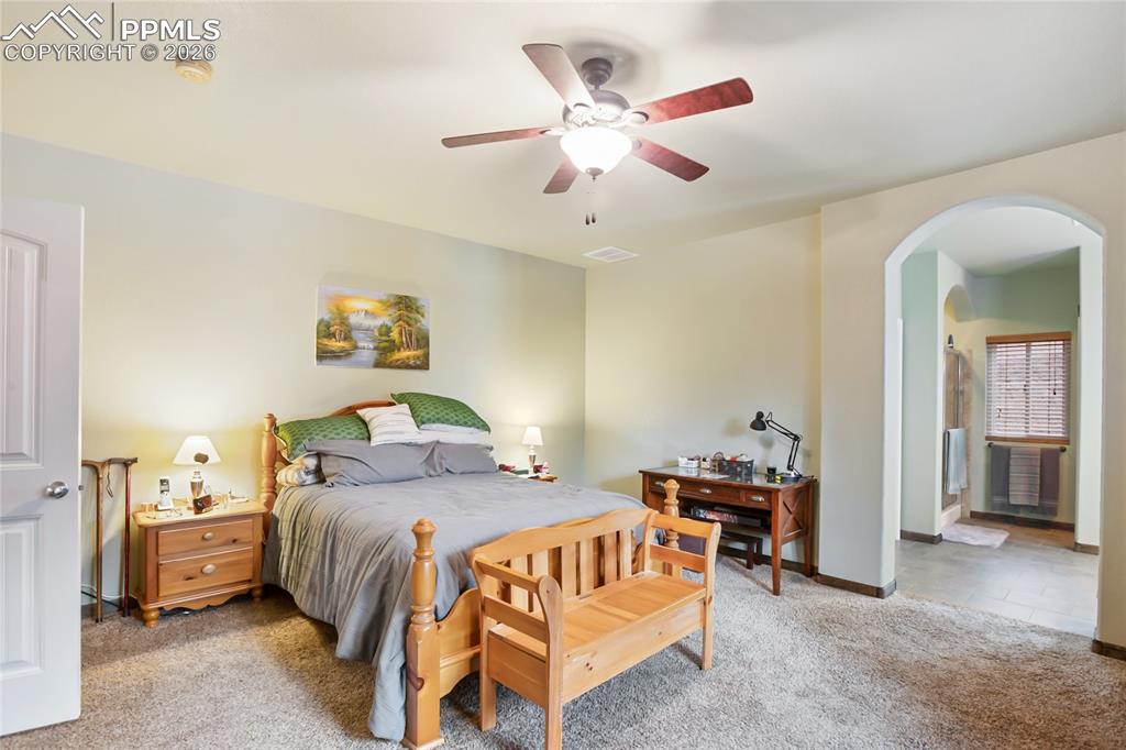 Image 11 of 33: The main bedroom with an arched walkway into an en-suite bathroom!