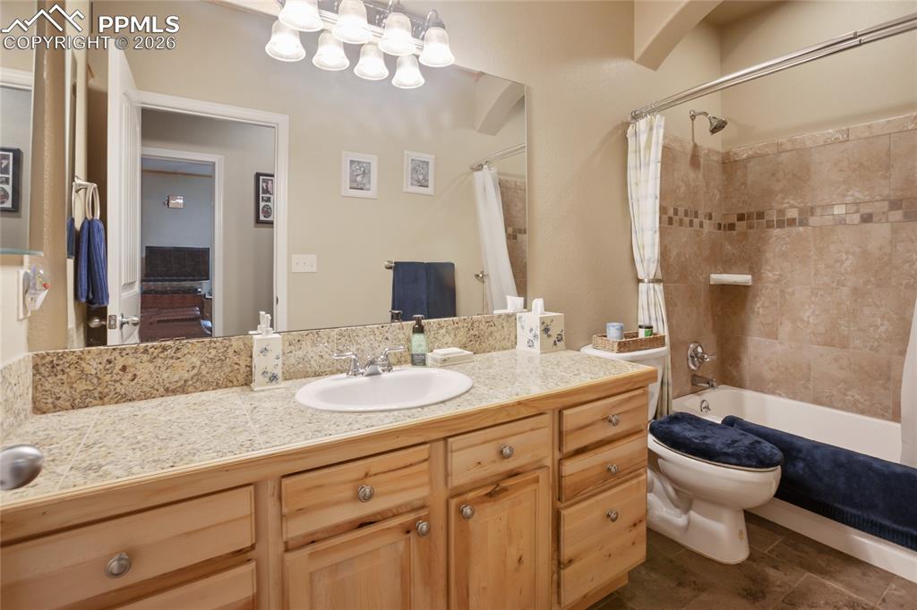 Image 13 of 33: A Full bathroom featuring a vanity and a shower / bath combination with gra