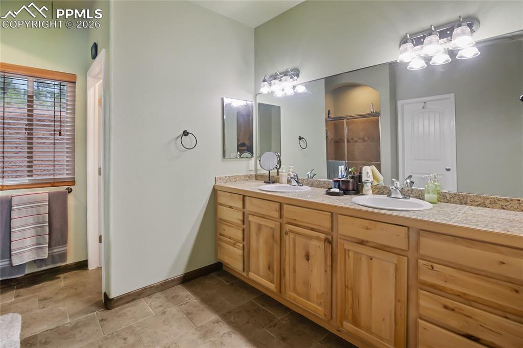 Image 14 of 33: A Full bathroom featuring double vanity and the toilet room!