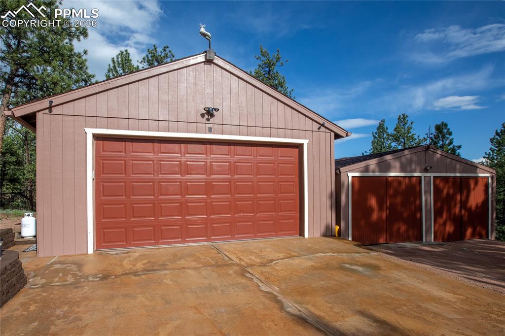 Image 25 of 33: The 2 car detached garage and the matching storage shed!
