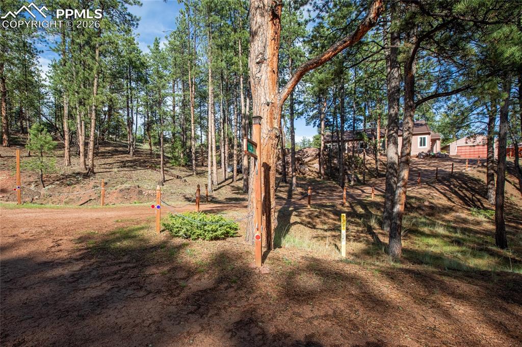 Image 30 of 33: The view of the house from the street. The home is privately set back from 