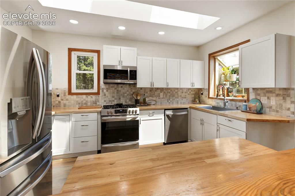 Image 13 of 27: This kitchen is so sunny and bright!