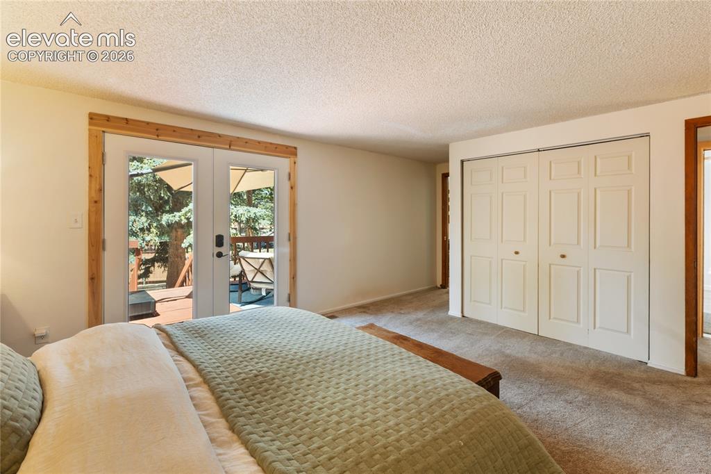 Image 14 of 27: Welcome to the Primary bedroom with a walk out to the back balcony!