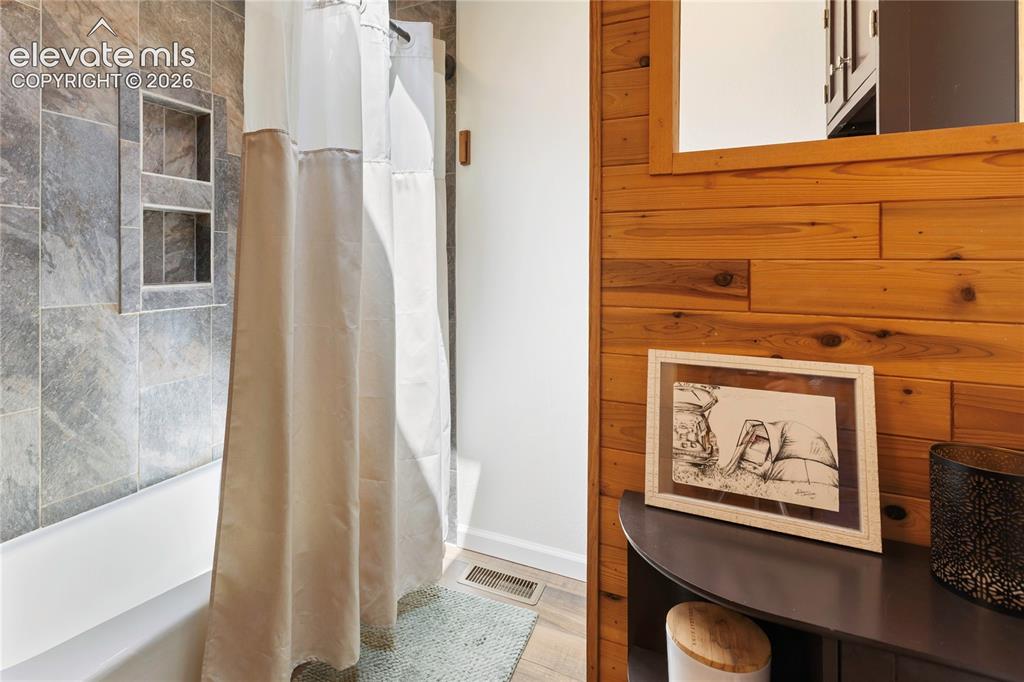 Image 16 of 27: The upper level bathroom has been updated for convenience but still maintai