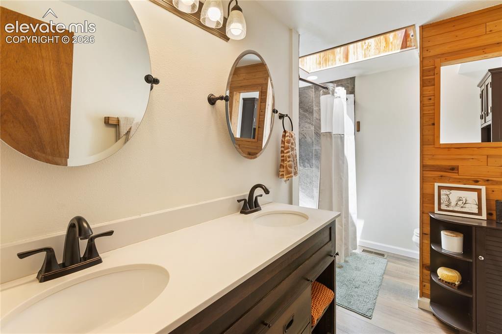 Image 17 of 27: Spacious and attractive with a floor to ceiling tile shower.