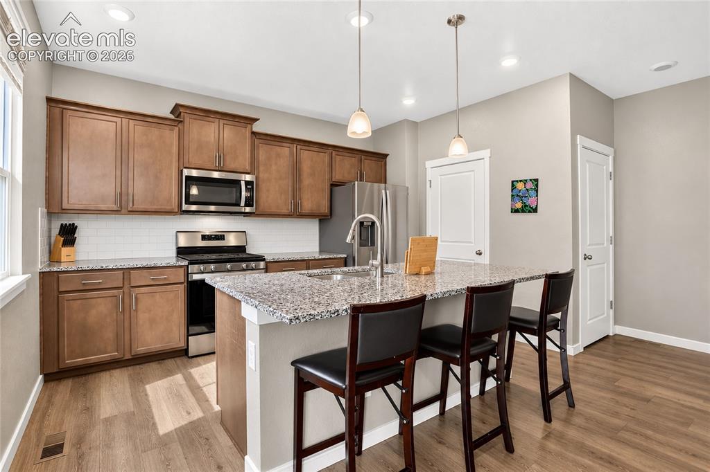 Image 7 of 20: Kitchen island with barstool seating 