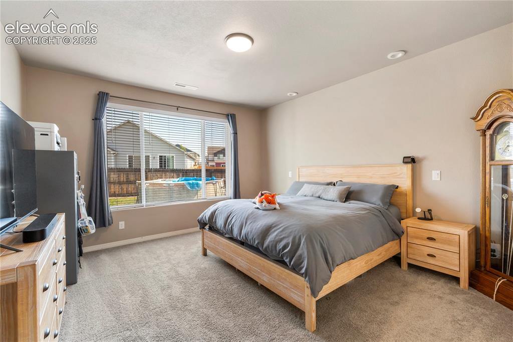 Image 11 of 20: Another view of primary bedroom on main level