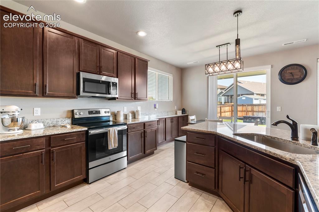 Image 4 of 20: Custom tile flooring in kitchen