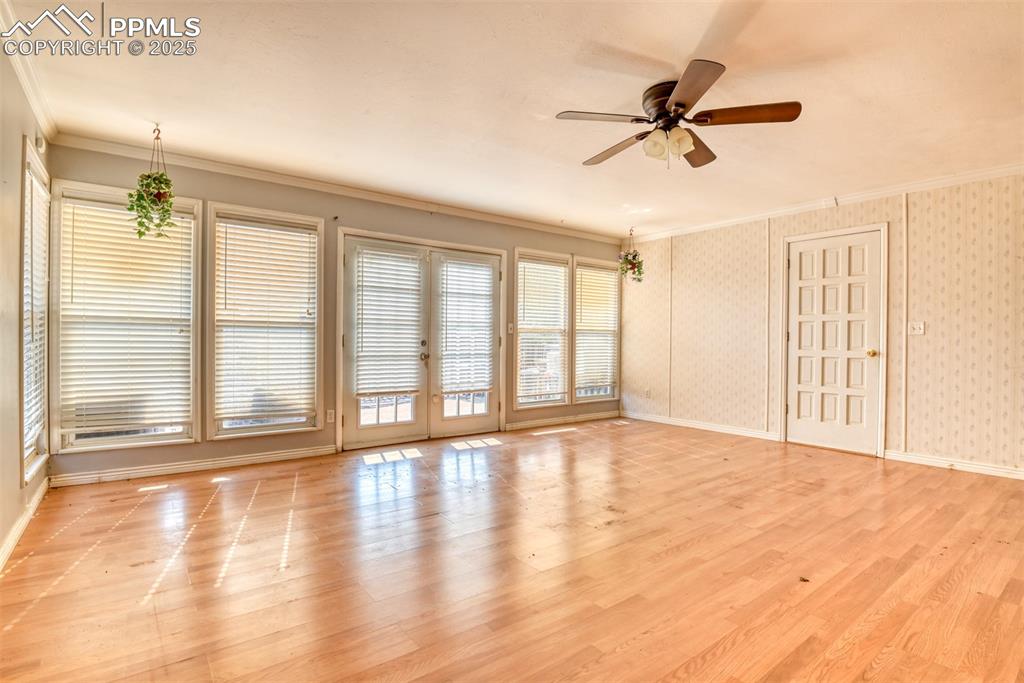 Image 17 of 44: Family room features easy maintenance laminate flooring and walks out to th